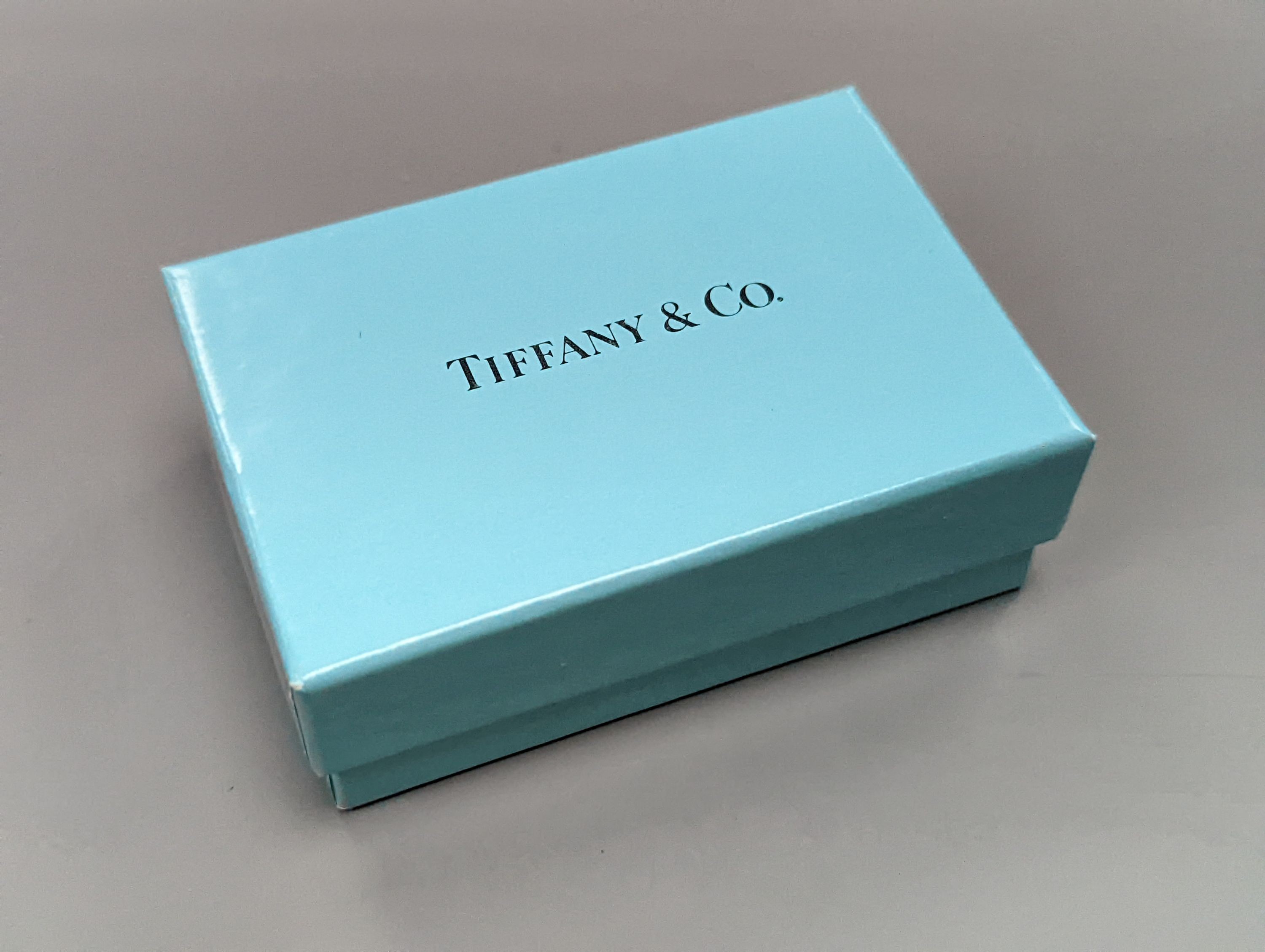 A boxed Tiffany & Co sterling silver money clip, and Parker and Sheffer fountain pens.